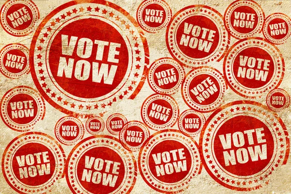 Vote agora, carimbo vermelho em uma textura de papel grunge — Fotografia de Stock