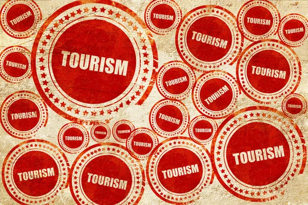 Turismo, sello rojo en una textura de papel grunge — Foto de Stock