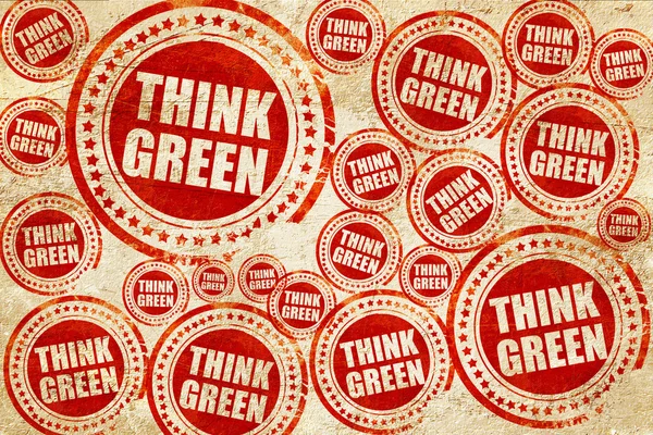 Pensar verde, carimbo vermelho em uma textura de papel grunge — Fotografia de Stock