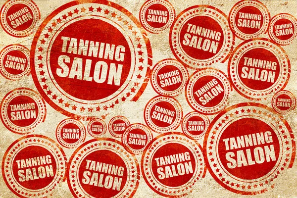 Tanning salon, red stamp on a grunge paper texture — Stock Photo, Image