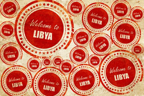 Bienvenue à libya, timbre rouge sur une texture de papier grunge — Photo