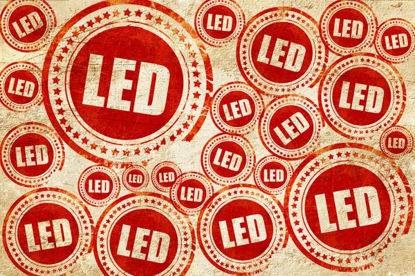 LED, czerwony znaczek na grunge tekstury papieru — Zdjęcie stockowe
