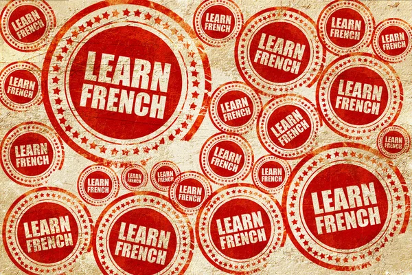Apprendre le français, timbre rouge sur une texture de papier grunge — Photo