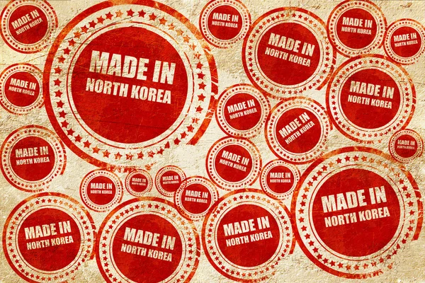 Feito na Coréia do Norte, selo vermelho em uma textura de papel grunge — Fotografia de Stock