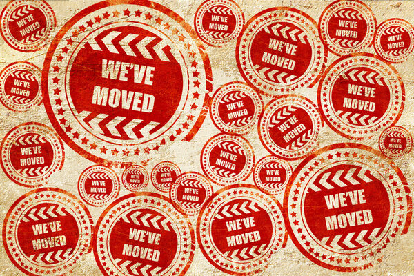 Weve moved sign, red stamp on a grunge paper texture