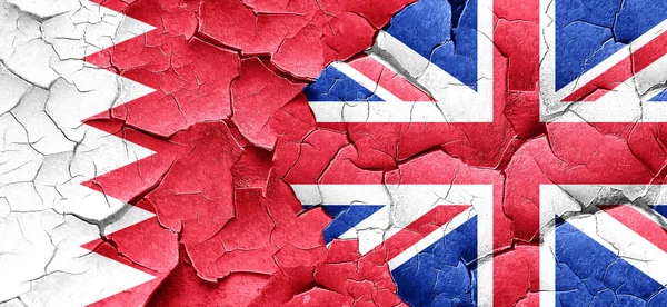 Bahrain flag with Great Britain flag on a grunge cracked wall — Stock Photo, Image