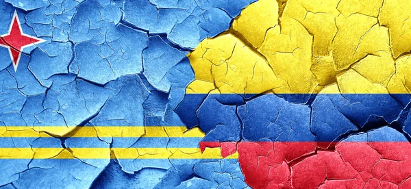 Aruba flag with Colombia flag on a grunge cracked wall — Stock Photo, Image