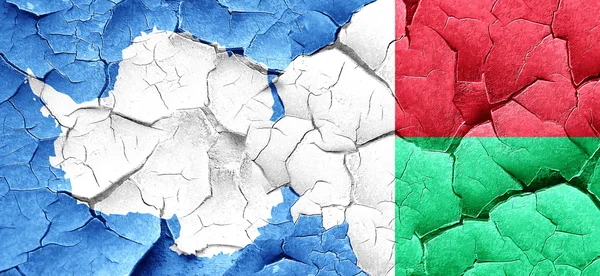 Antarctica flag with Madagascar flag on a grunge cracked wall — Stock Photo, Image