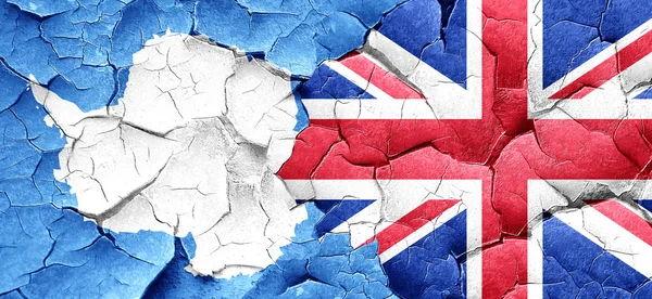 Antarctica flag with Great Britain flag on a grunge cracked wall — Stock Photo, Image