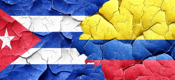 Cuba flag with Colombia flag on a grunge cracked wall