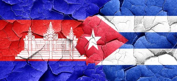 Cambodia flag with cuba flag on a grunge cracked wall — Stock Photo, Image