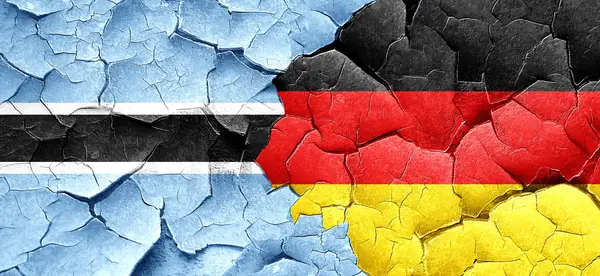 Прапор Ботсвани з прапором Німеччини на за гранж тріщинами стіни — стокове фото