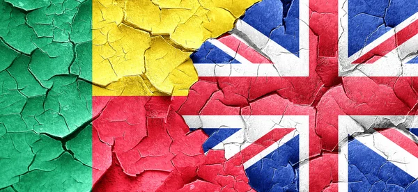 Benin flag with Great Britain flag on a grunge cracked wall