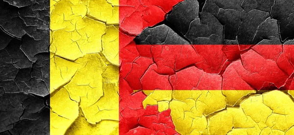 Belgium flag with Germany flag on a grunge cracked wall — Stock Photo, Image