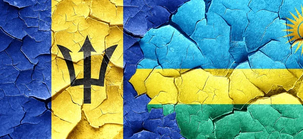Bandera de Barbados con bandera de Ruanda en una pared agrietada grunge — Foto de Stock