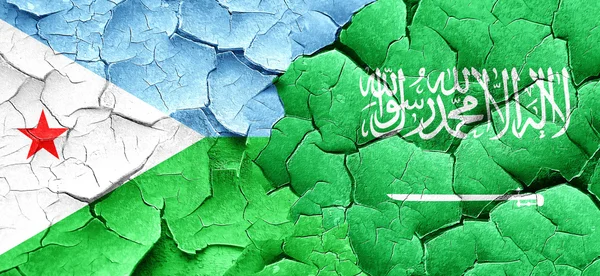 Djibouti flag with Saudi Arabia flag on a grunge cracked wall