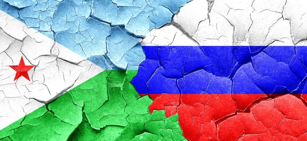 Djibouti flag with Russia flag on a grunge cracked wall