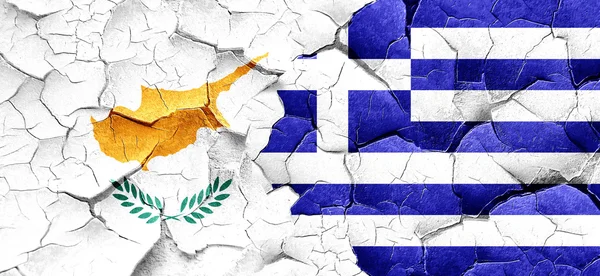 Cyprus flag with Greece flag on a grunge cracked wall