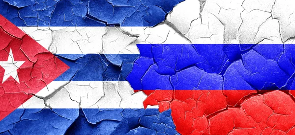 Cuba flag with Russia flag on a grunge cracked wall — Stock Photo, Image