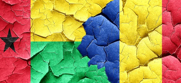 Guinea bissau flag with Romania flag on a grunge cracked wall — Stock Photo, Image