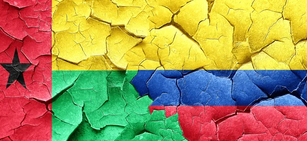 Guinea bissau flag with Colombia flag on a grunge cracked wall — Stock Photo, Image