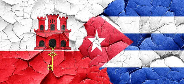 Gibraltar flag with cuba flag on a grunge cracked wall — Stock Photo, Image