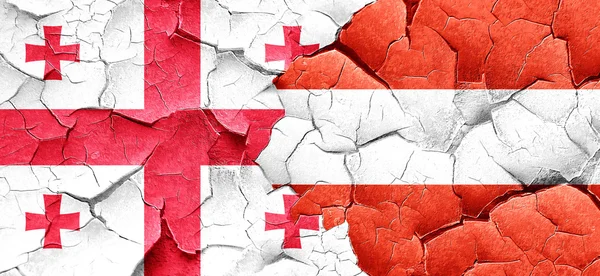 Georgia vlajky s vlajkou Rakouska na grunge popraskané zdi — Stock fotografie