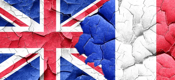 Great britain flag with France flag on a grunge cracked wall — Stock Photo, Image