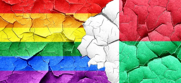 Gay pride flag with Madagascar flag on a grunge cracked wall — Stock Photo, Image