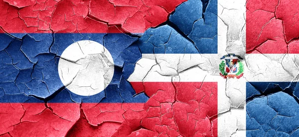 Laos flag with Dominican Republic flag on a grunge cracked wall — Stock Photo, Image