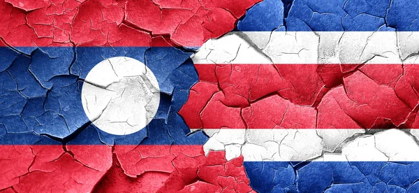 Bandera de Laos con bandera de Costa Rica en una pared agrietada grunge —  Fotos de Stock