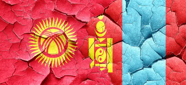 Kyrgyzstan flag with Mongolia flag on a grunge cracked wall — Stock Photo, Image