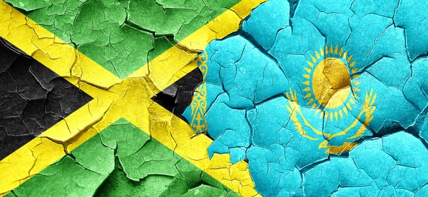 Jamaica flag with Kazakhstan flag on a grunge cracked wall