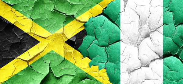 Jamaica flag with Nigeria flag on a grunge cracked wall