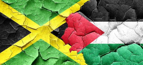 Jamaica flag with Palestine flag on a grunge cracked wall — Stock Photo, Image