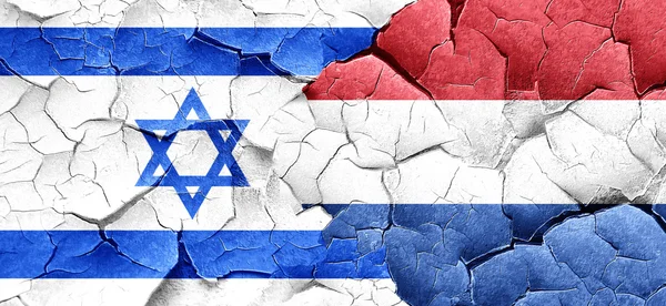 Israel flag with Netherlands flag on a grunge cracked wall