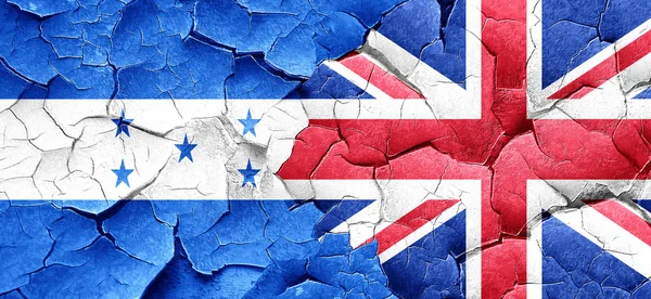 Honduras flag with Great Britain flag on a grunge cracked wall — Stock Photo, Image