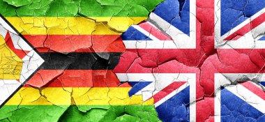 Zimbabve bayrağı bir grunge Büyük Britanya bayrağı ile duvar kırık