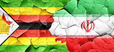 Zimbabve bayrağı bir grunge Iran bayrağı ile duvar kırık