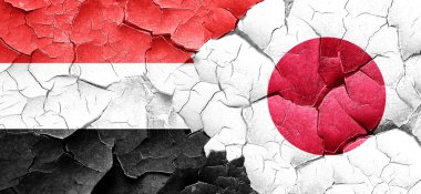 Yemen bayrak bir grunge Japonya bayrağı ile duvar kırık