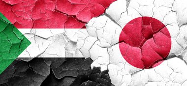 Sudan bayrağı bir grunge Japonya bayrağı ile duvar kırık