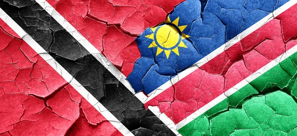 Trinidad en tobago vlag met Namibië vlag op een grunge gebarsten w — Stockfoto