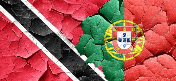 Trinidad en tobago vlag met Portugal vlag op een grunge gekraakt — Stockfoto