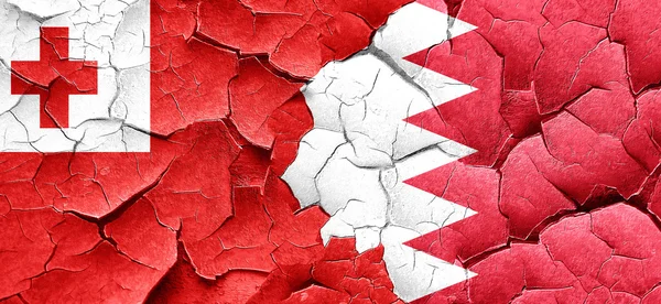 Tonga flag with Bahrain flag on a grunge cracked wall — Stock Photo, Image