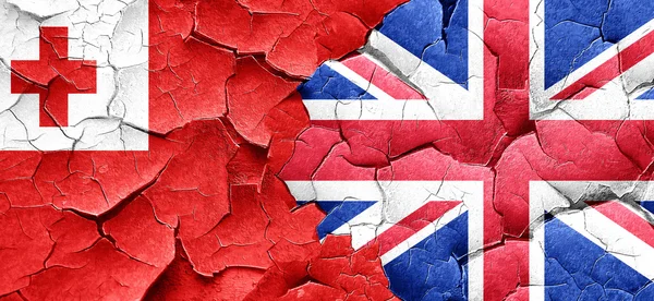Tonga flag with Great Britain flag on a grunge cracked wall — Stock Photo, Image
