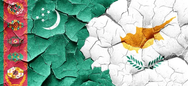 Turkmenistan flag with Cyprus flag on a grunge cracked wall