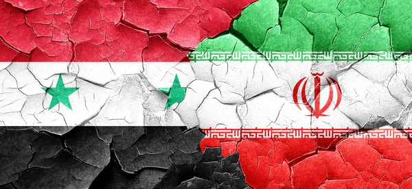 Syria flag with Iran flag on a grunge cracked wall