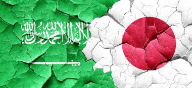 Suudi Arabistan bayrağı bir grunge Japonya bayrağı ile duvar kırık