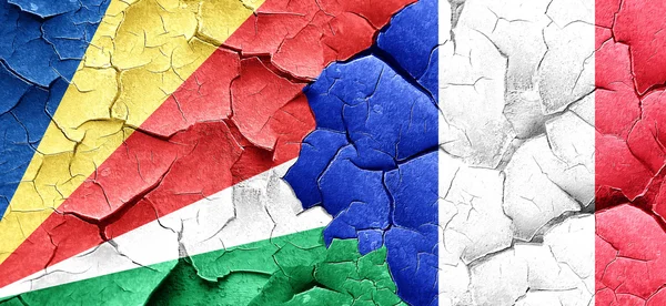 Seychelles flag with France flag on a grunge cracked wall — Stock Photo, Image