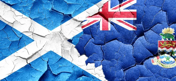 Scotland flag with Cayman islands flag on a grunge cracked wall — Stock Photo, Image